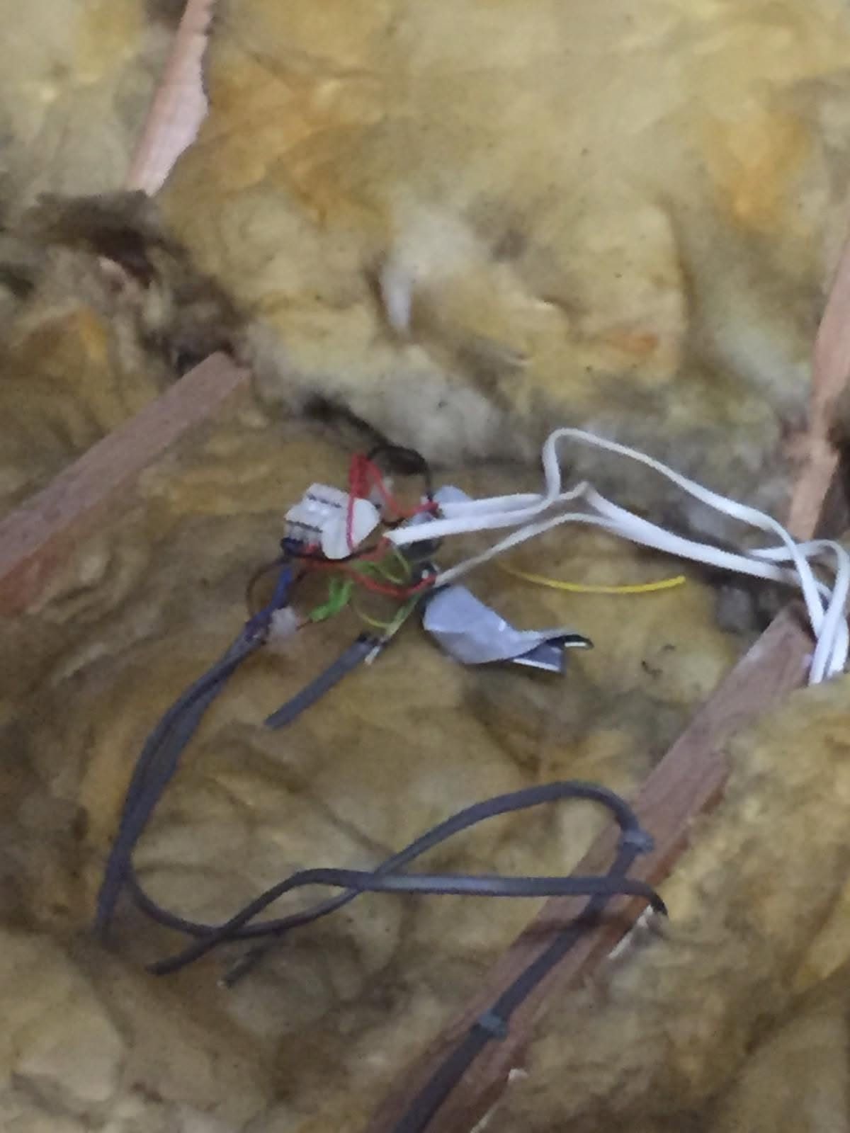 Loose cables and connector blocks lying in loft insulation