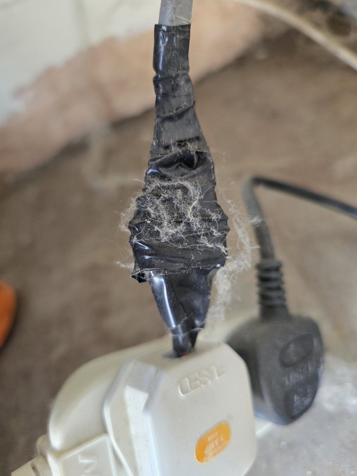 A taped-up extension lead joint powering a shed