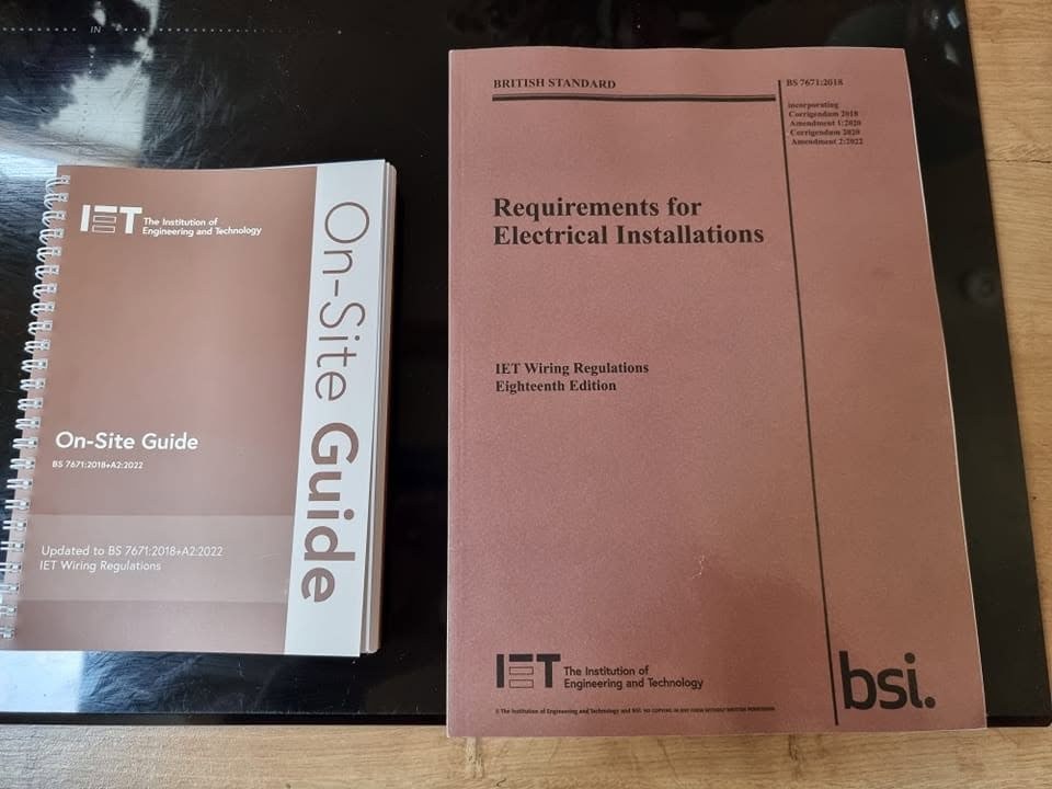 The IET On-Site Guide and the wiring regulations book on a table