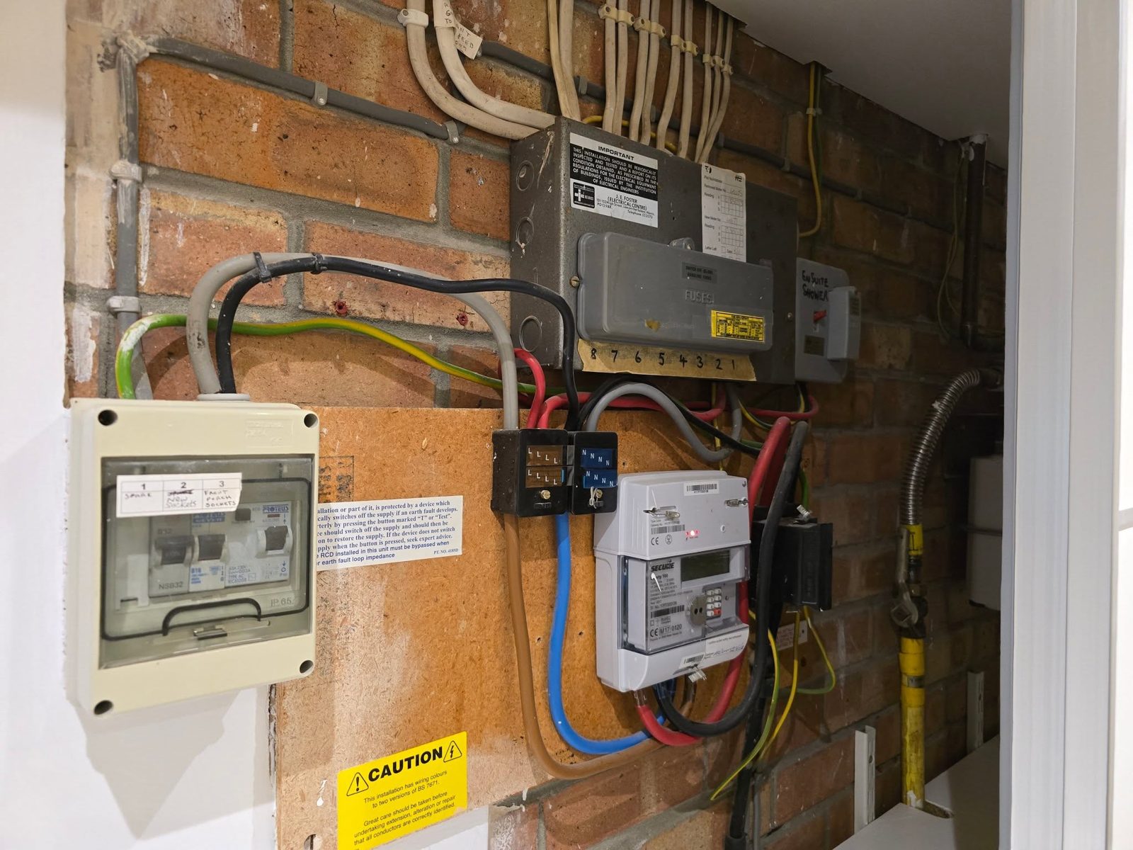 The same wall with the older fuse boards and meter tails