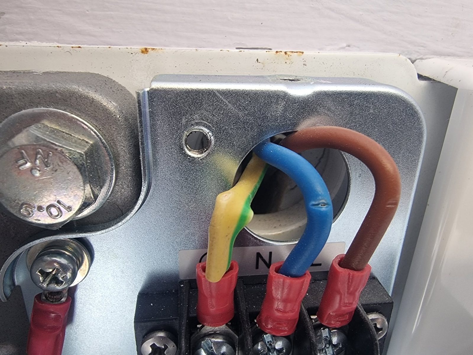 Crimped cable terminations entering a metal enclosure
